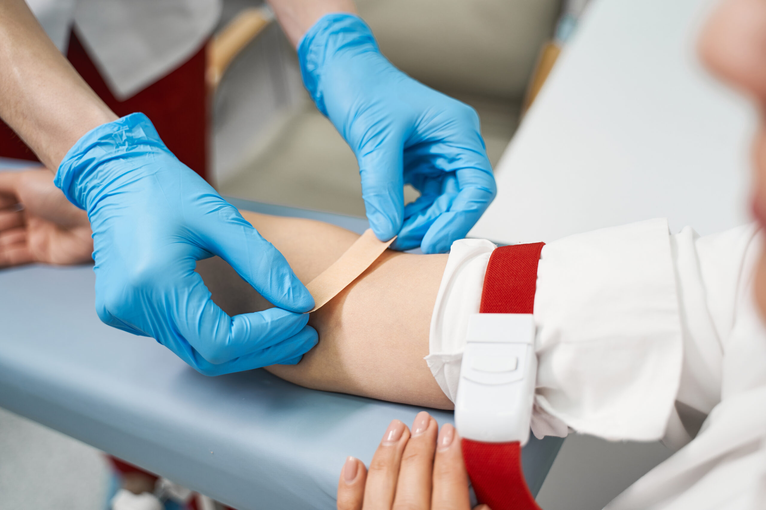 professional medical worker putting plaster on arm